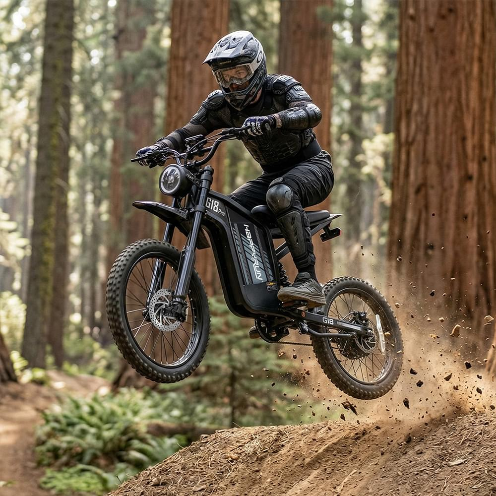 A rider wearing full protective gear jumps the HappyRun pedal assist Electric Dirt Bike G18 Pro over a dirt trail in a forest