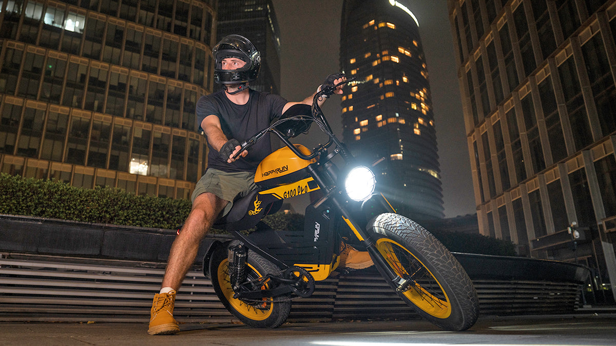 Rider on a HappyRun G100 Pro fat tire e-bike at night in the city