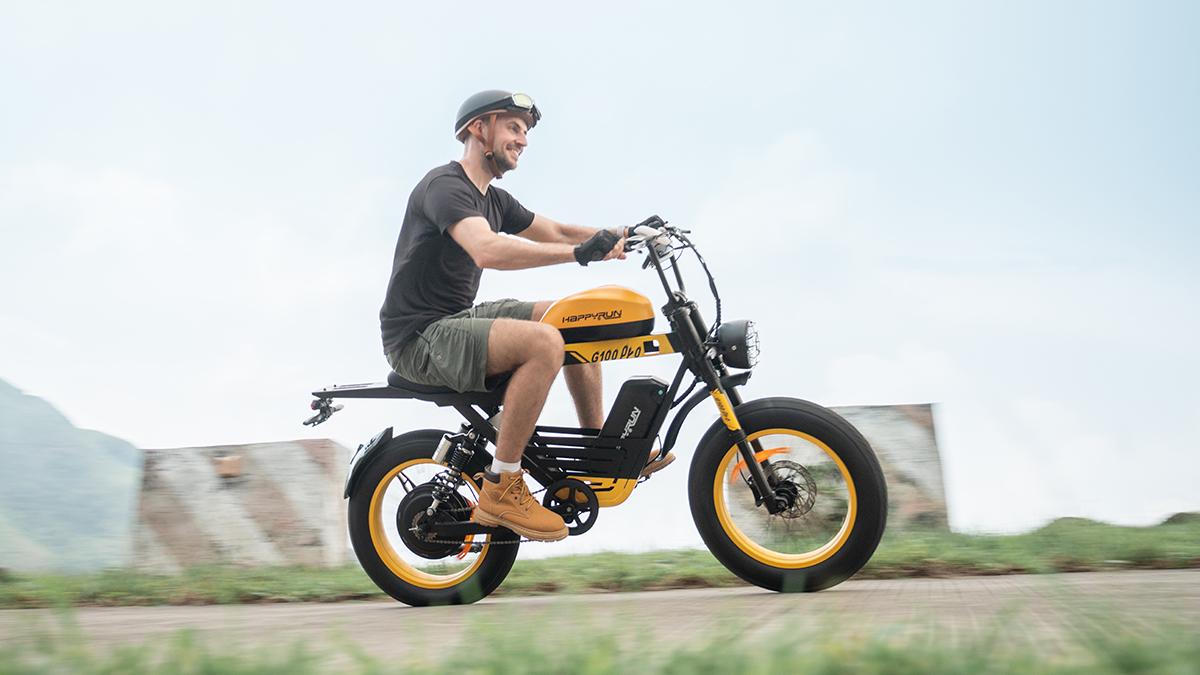 Smiling rider in a helmet on a yellow and black HappyRun G100 Pro  best electric motocross bike